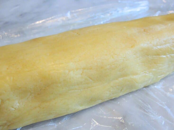 close up of spring icebox cookie dough in a snake form ready to freeze
