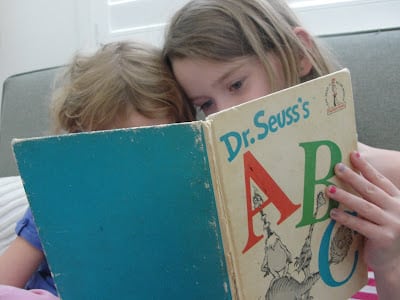 children sitting reading dr. seuss ABC book