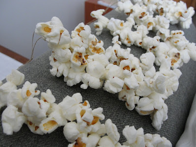 popcorn bunches on loops of thread to be hung on tree for birds