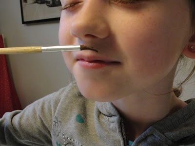 child smelling the indian spices