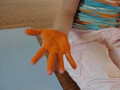 child's hand with paint