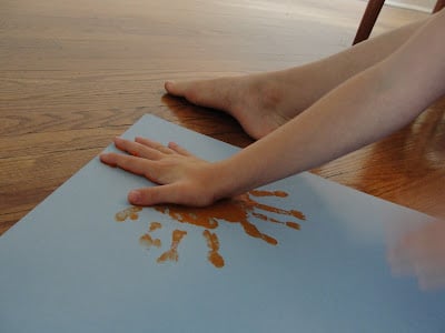 child's handprint painting the sun