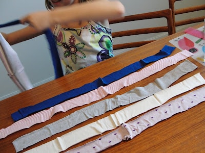 child sorting t-shirt strips for dog toy