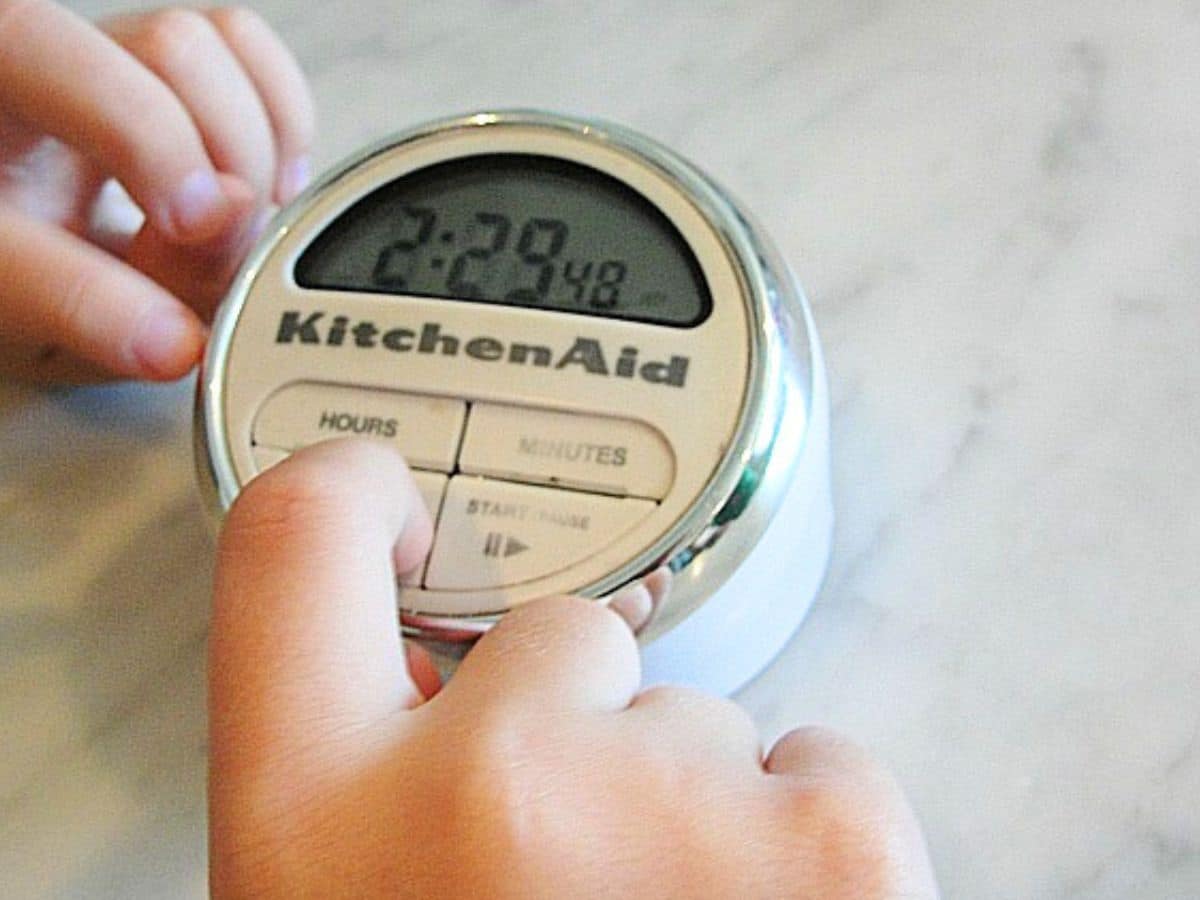 child with timer in hands