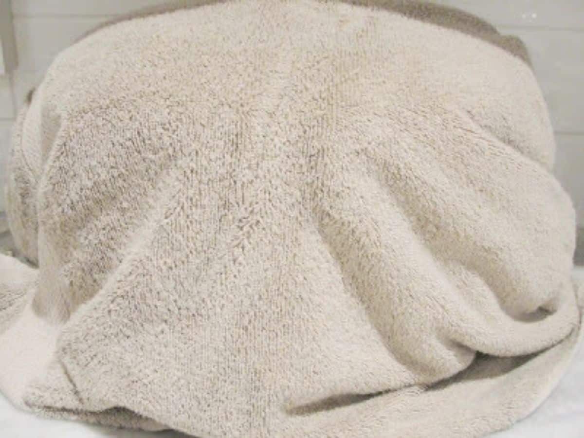 crock pot covered in towel on counter top