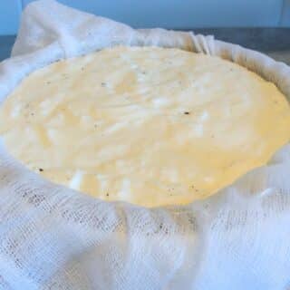 homemade vanilla yogurt in cheesecloth lined bowl