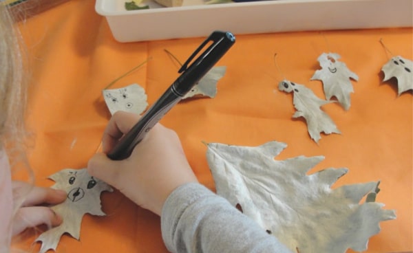 drawing faces on painted leaves