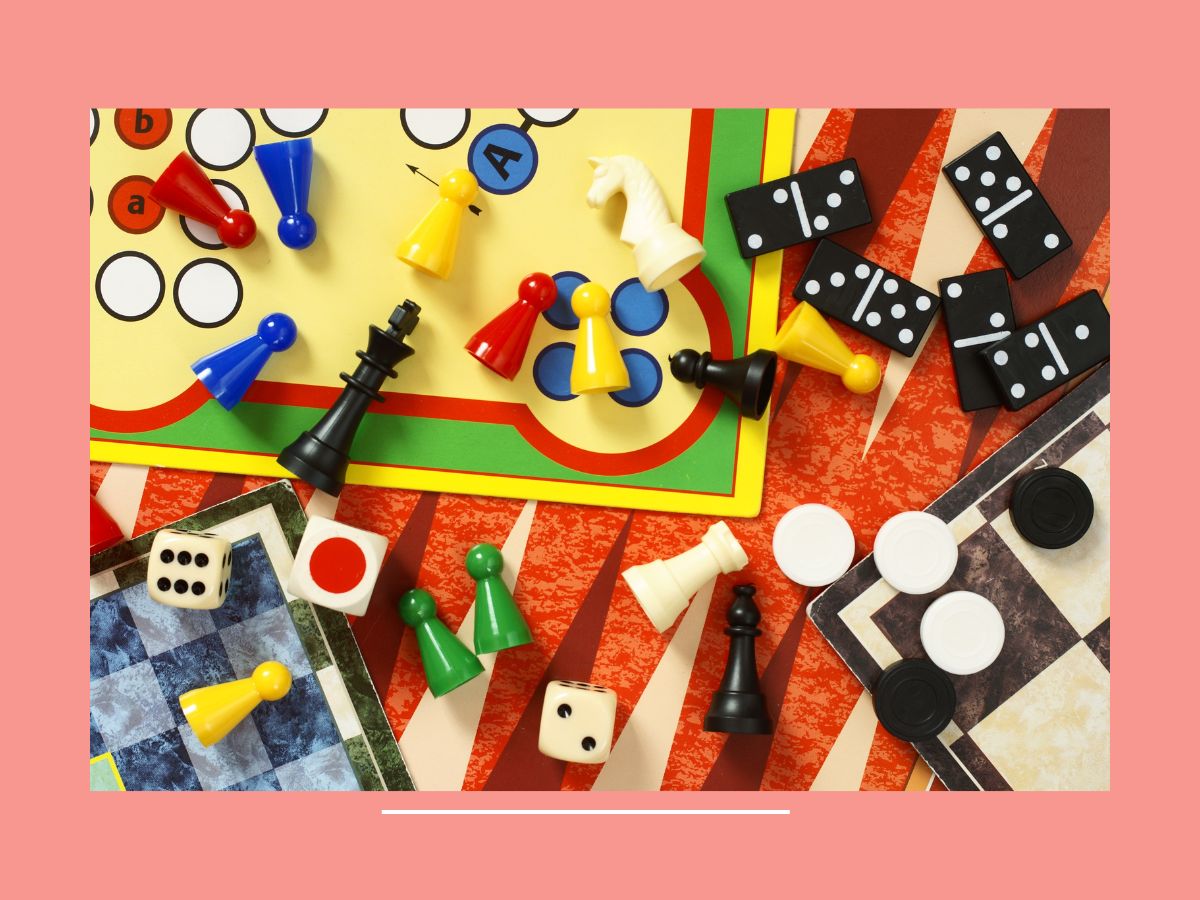 board games and playing pieces in a pile on table