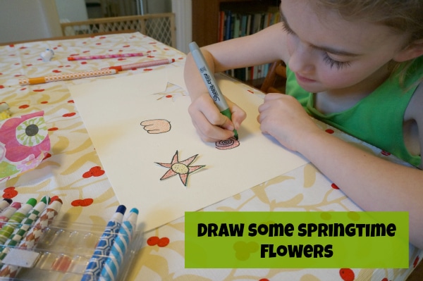 child drawing flowers