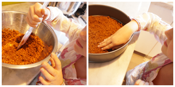 child pressing ginger snap crust into springform pan