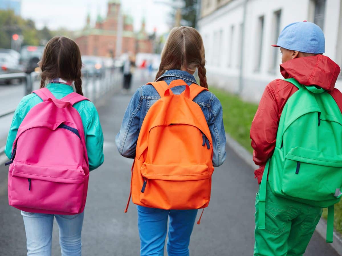 3 kids walking to school together