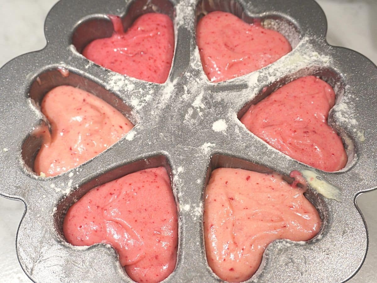valentines day cake batter in heart shaped baking pan