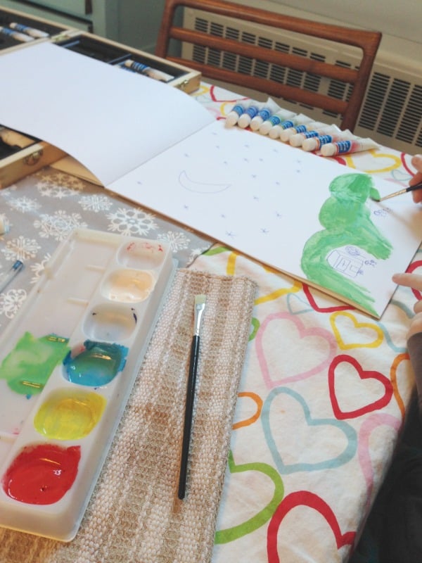 kid with paints and painting