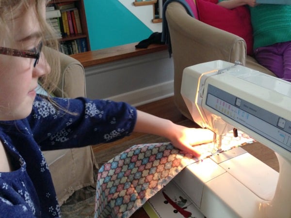 child at sewing machine