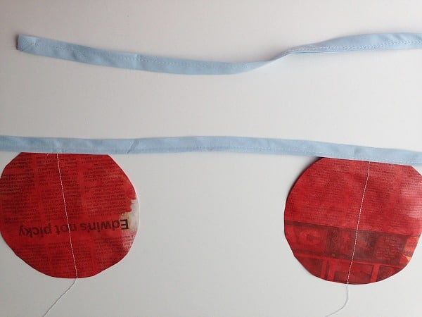 blue bias tape sewn on red discs