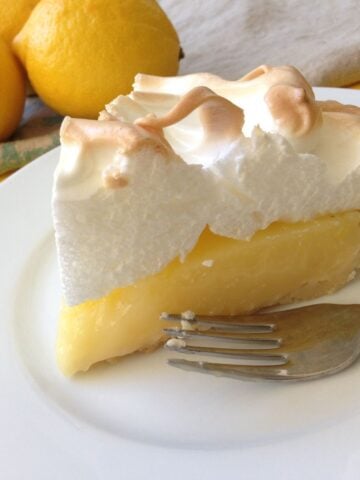 close up of slice of lemon meringue pie