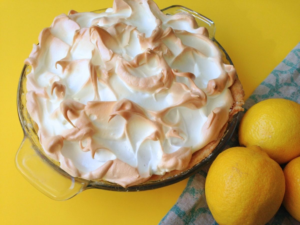 lemon meringue pie beside lemons