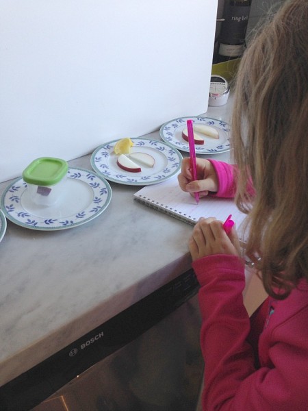 kid with apple science experiment