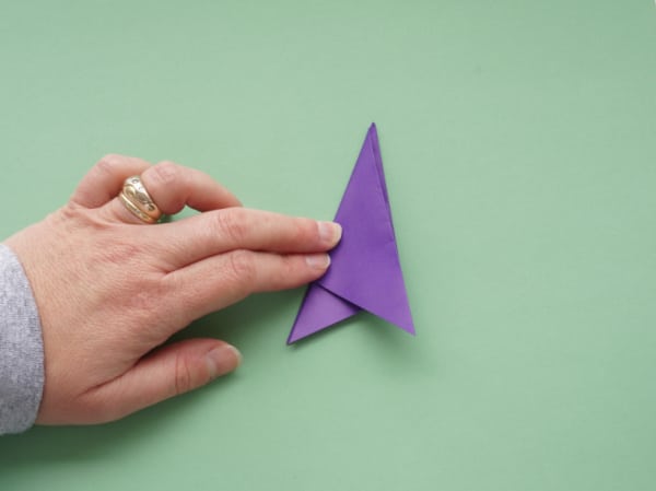 how to fold a paper snowflake paper in thirds with fingers pressing the folds