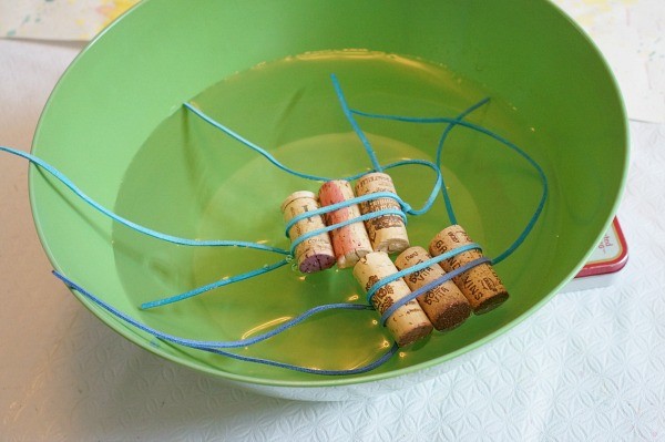 cork raft the corks tied together and floating in a bowl of water