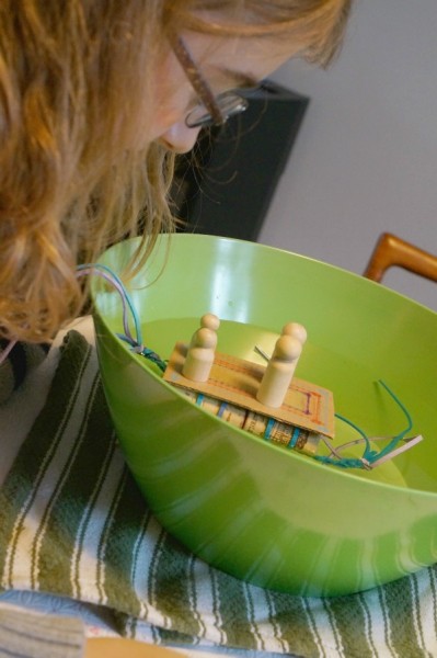 cork raft floating in a bowl of water 