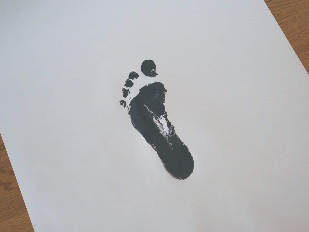 carbon footprint black footprint painted on board