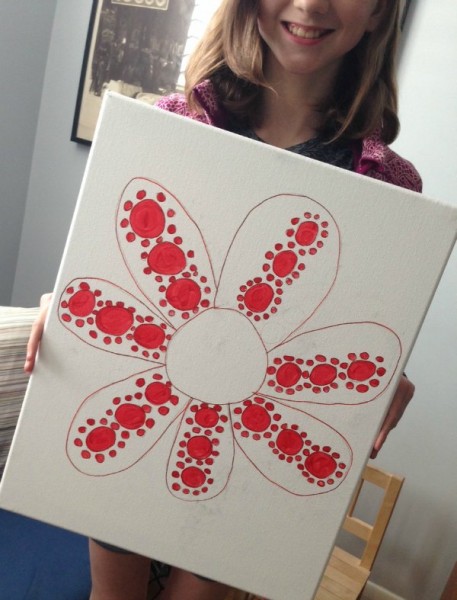 child holding a red polka dot flower inspired by yayoi kusama