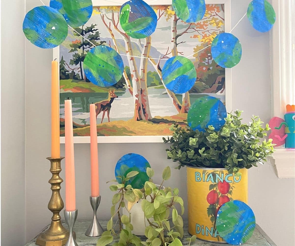 Recycled Newspaper Earth Day Garland hanging with tablescape