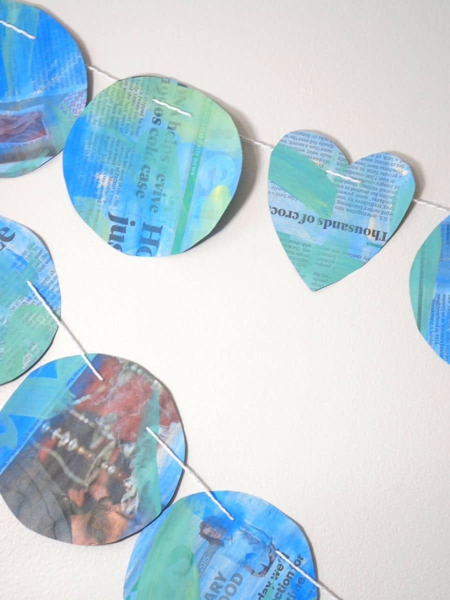 earth day newspaper garland hanging on wall
