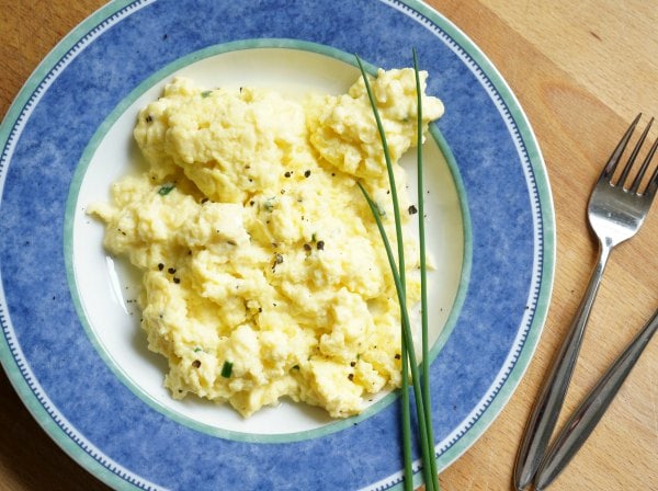 chive and cheese scrambled eggs in bowl with fork