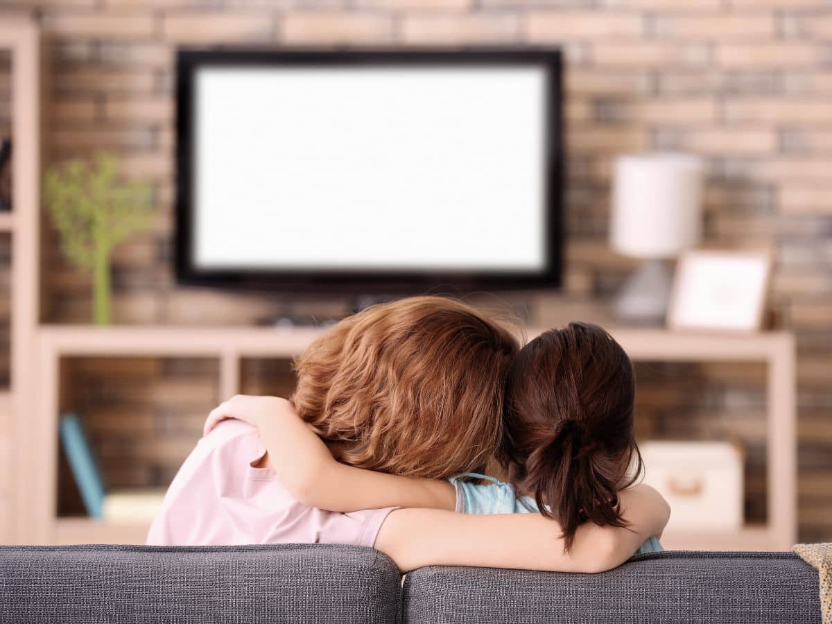 tween and mom watching tv together on the couch