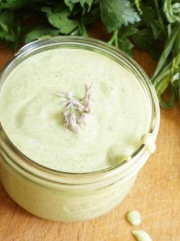 close up of green goddess dressing in a mason jar