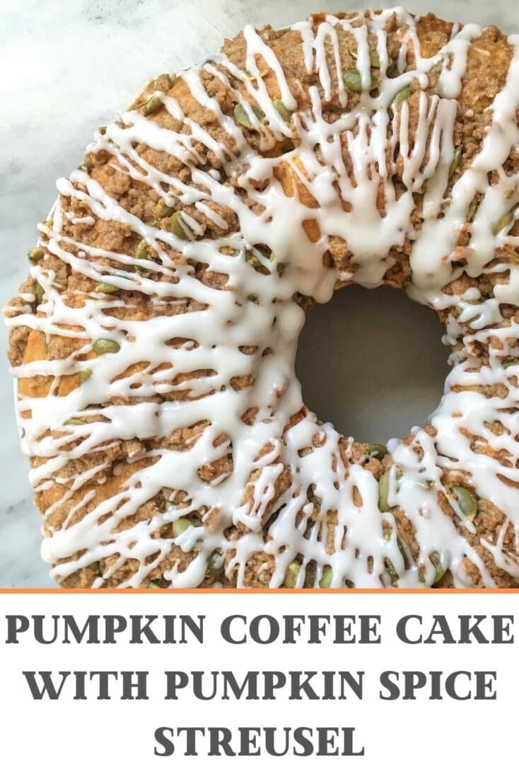 pumpkin coffee cake with vanilla glaze on marble counter