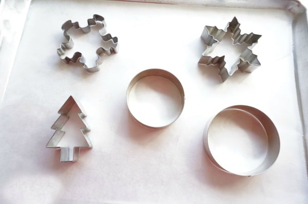 christmas cookie cutters on parchment paper