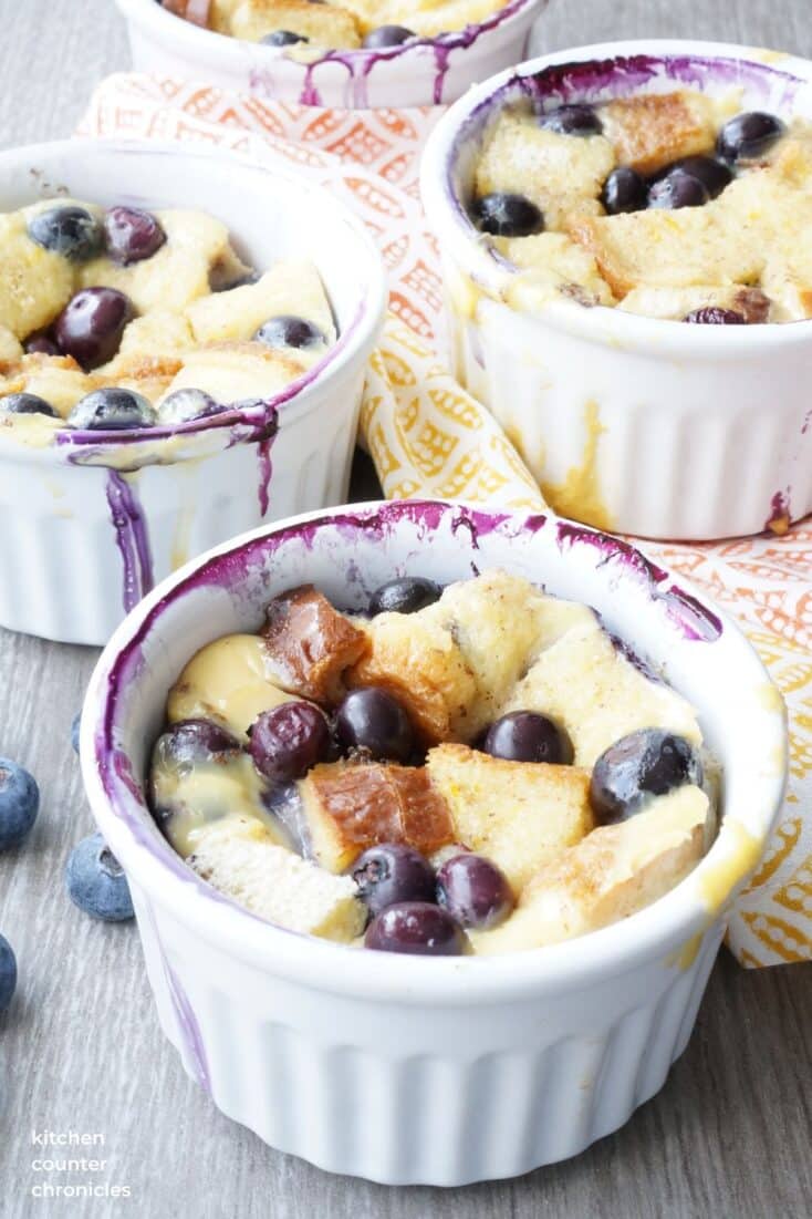 3 blueberry bread pudding in ramekins