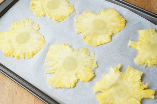pineapple sliced on baking sheet