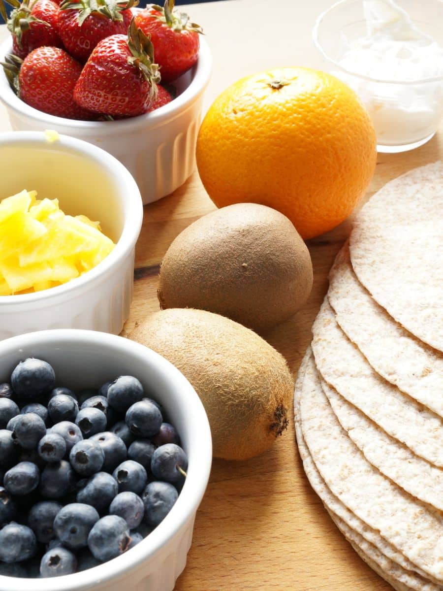 a variety of fresh fruit and tortillas and yogurt for rainbow wraps