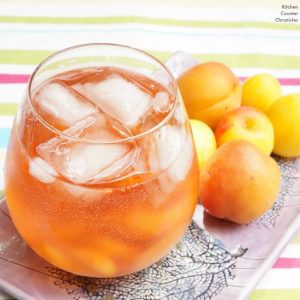 rose sangria spritzer with stone fruit on purple tray