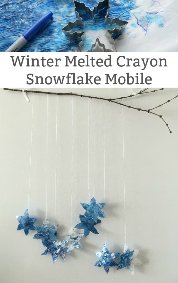 winter melted crayon snowflake mobile - A lovely winter craft for kids to make. Gather up your old crayons and snowflake cookie cutters to make a beautiful snowflake mobile. #wintercraft #snowflake #snowcraft #mobilecraft #craftforkids