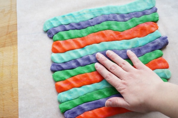 pressing rolls of coloured dough together