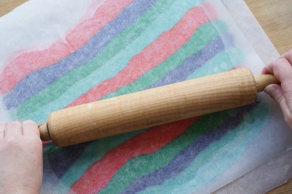 rolling out rainbow cookie dough with rolling pin