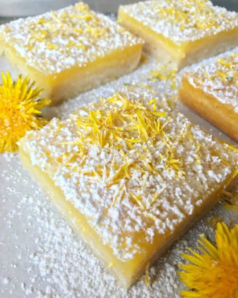 lemon dandelion bars sitting on a plate