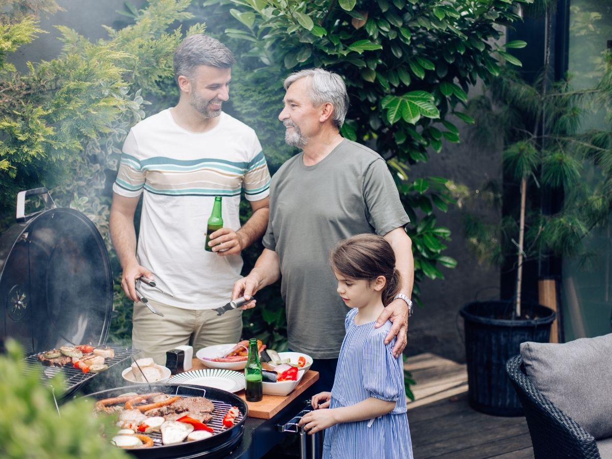 dad with grandpa and child at barbecue