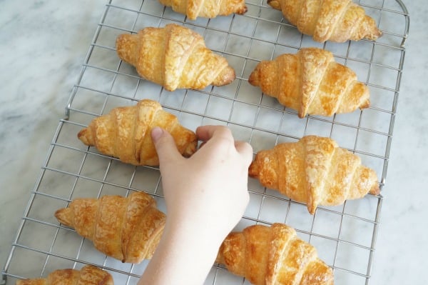 baked croissants on cooling rack