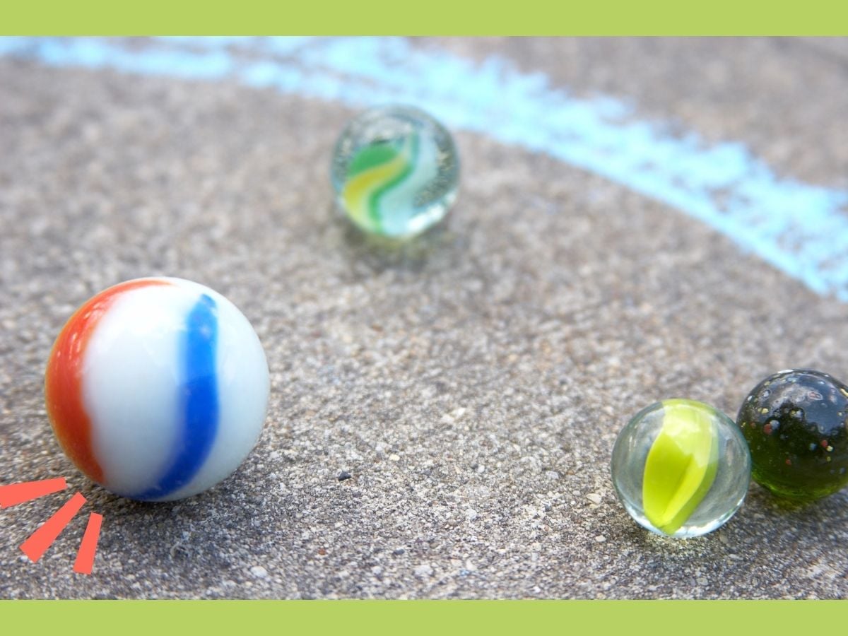 close up of a game of marbles on sidewalk