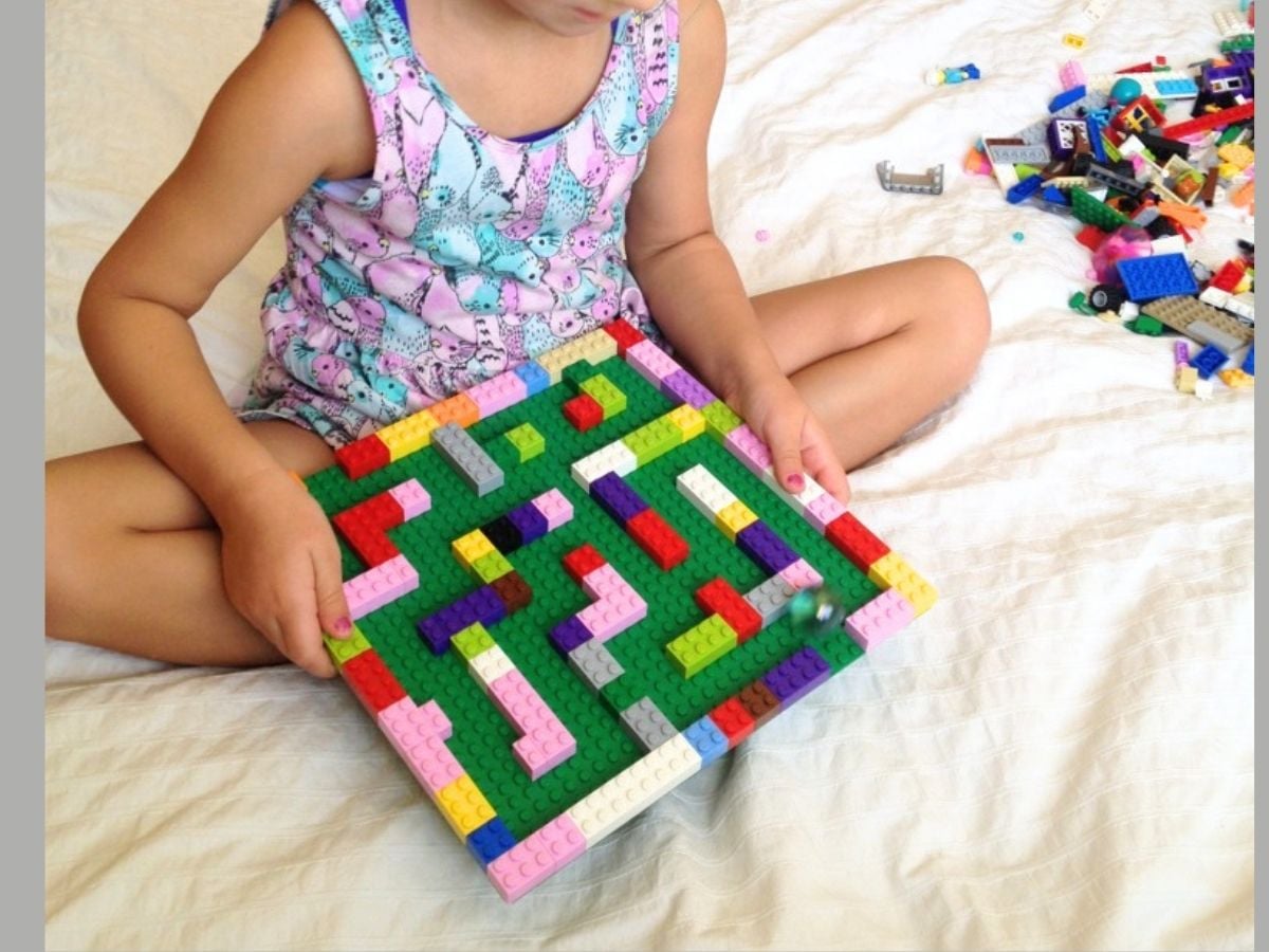kid-made lego marble run in child's hands