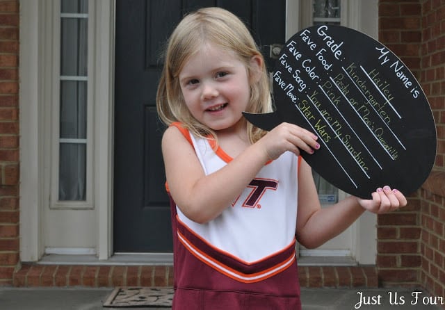 child holding a chalkboard first day of school sign photo prop