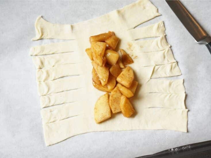 apple turnover mummy with apple mixture in middle of puff pastry and sliced puffed pastry