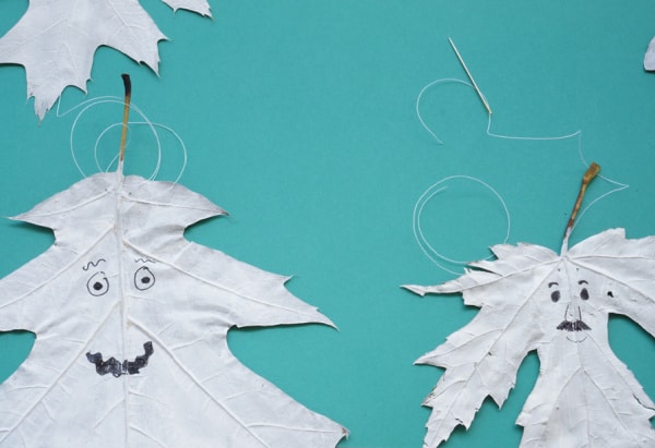 painted leaf ghosts with string fed through to hang