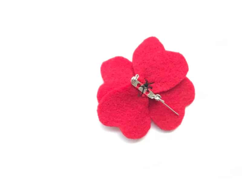 remembrance day poppy pin with pin sewn in place and centre